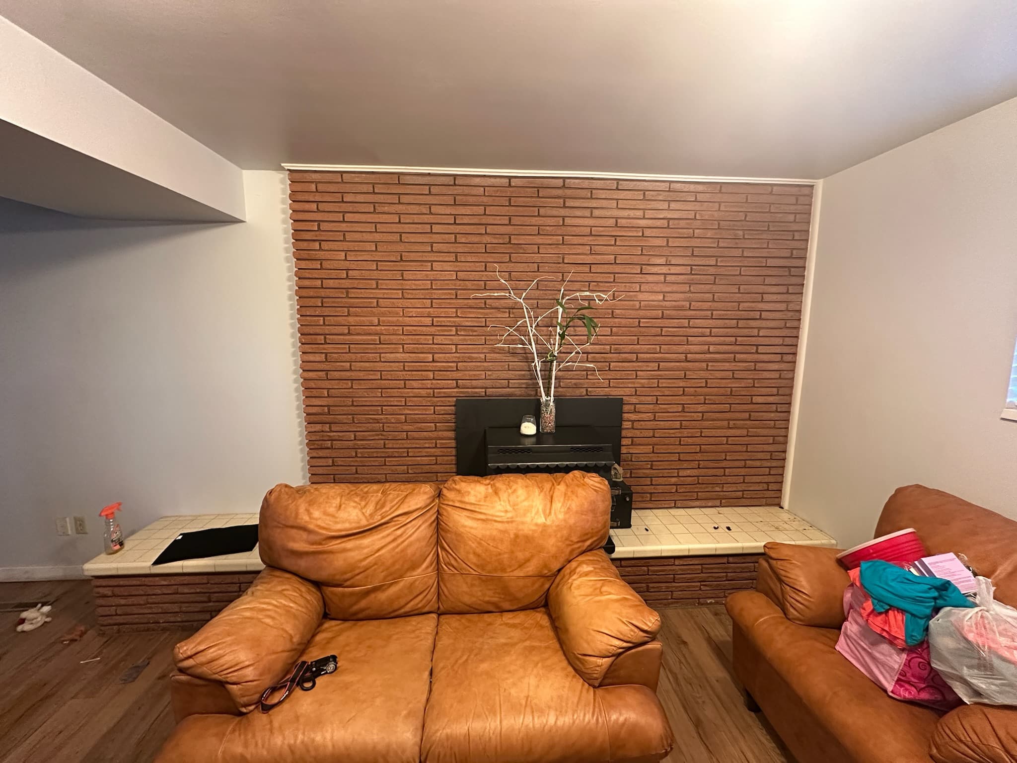 Brick fireplace wall before demo