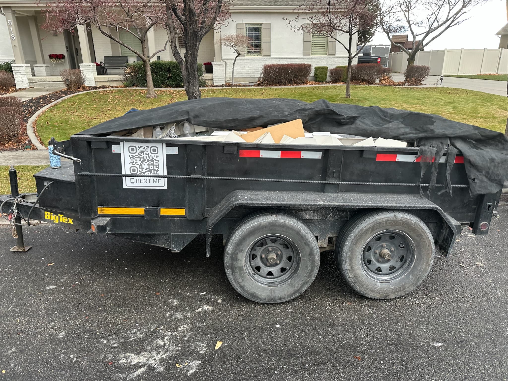 Loaded dump trailer hauling demo debris